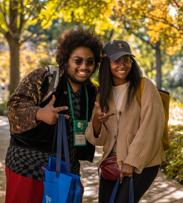 Two students outdoors smiling