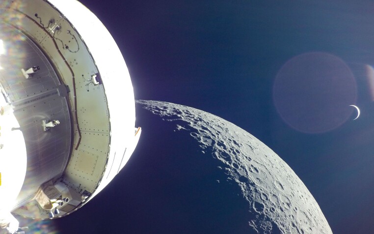 A photo taken by the Orion module of the Earth rising behind the Moon during 2022's Artemis I mission