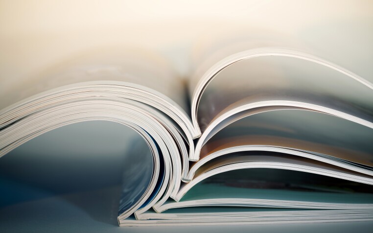 Abstract shot of open journals on table. Macro shot with shallow DOF