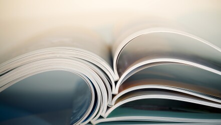 Abstract shot of open journals on table. Macro shot with shallow DOF