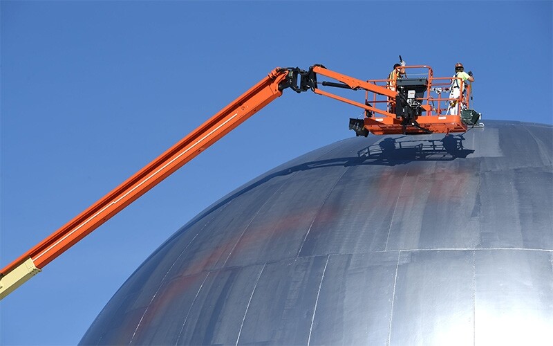 Workers painting the dome that once housed Idaho National Lab’s Experimental Breeder Reactor II facility. 