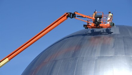 Workers painting the dome that once housed Idaho National Lab’s Experimental Breeder Reactor II facility. 