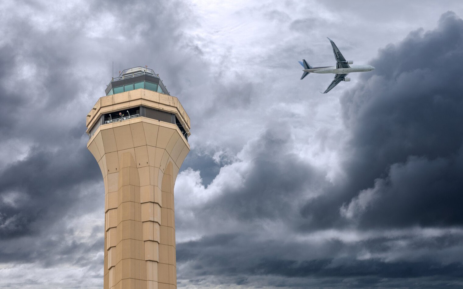 A plane flying over control tower