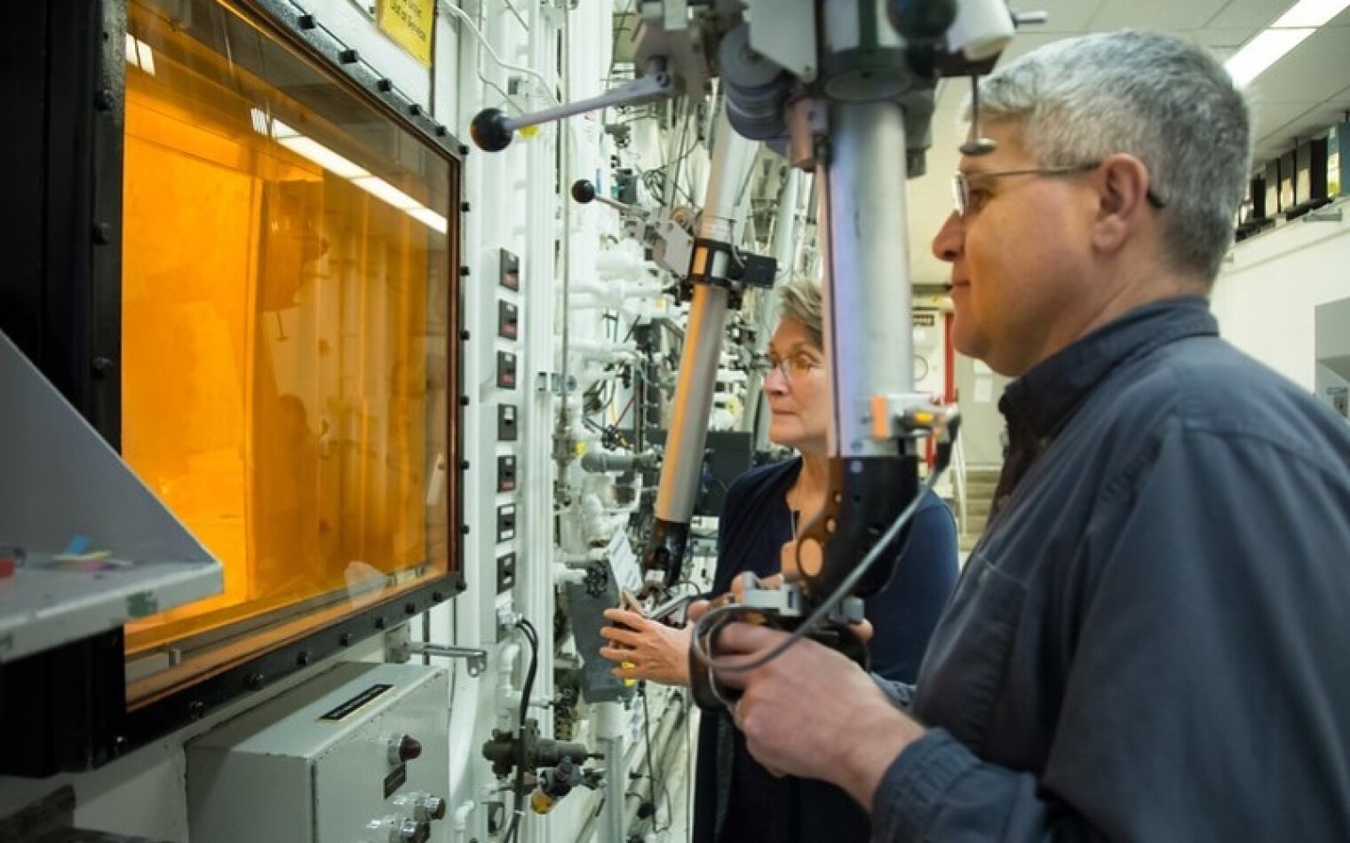 Technicians use hot cell manipulators at ORNL during the production of actinium-227