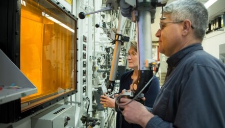 Technicians use hot cell manipulators at ORNL during the production of actinium-227