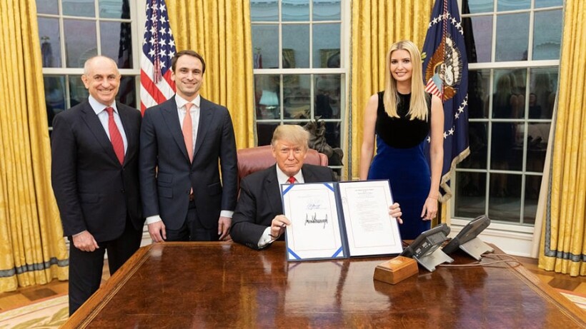 President Trump poses with the signed National Quantum Initiative Act.