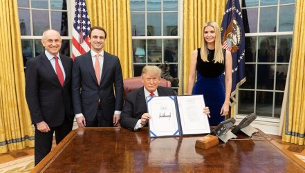 President Trump poses with the signed National Quantum Initiative Act.