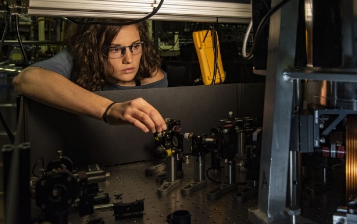 A NIST physicist steers a laser beam to perform novel measurements of a trapped beryllium ion, testing potential applications for quantum information processing.