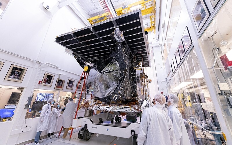 Psyche team members transporting the spacecraft to a vacuum testing chamber.